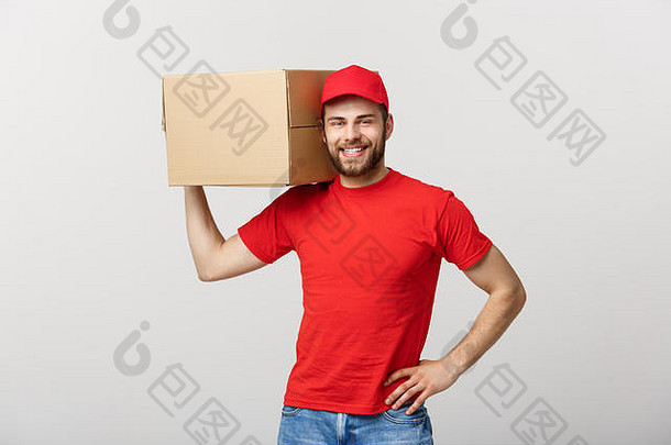 递送理念：年轻白种人英俊的递送员肩上扛着一个盒子。在灰色背景上隔离。