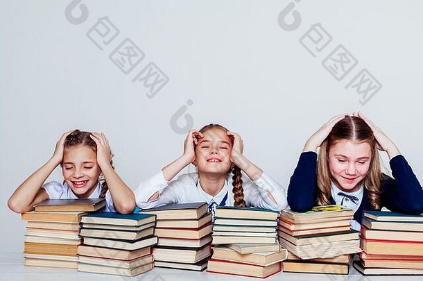 三个女孩在学校的教室里寻找知识书籍