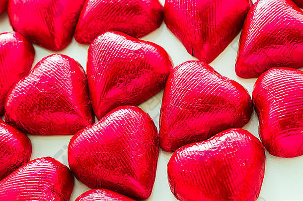 情人节用红色箔纸<strong>包裹</strong>的心形巧克力糖果。