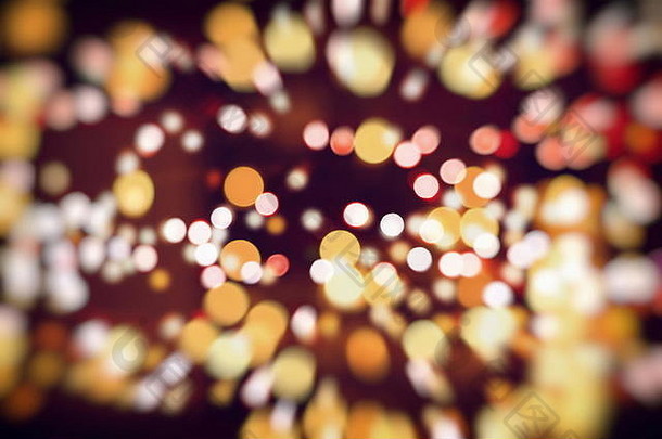 闪闪发光的灯泡背景灯：模糊的圣诞墙纸装饰概念。节日背景：闪亮的圆形灯光