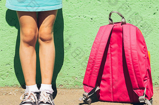女孩明亮的衣服运动鞋粉红色的背包绿色<strong>墙</strong>学校概念