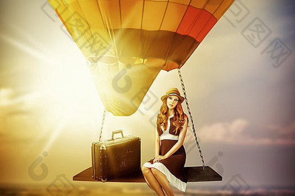 幻想旅行。驾驶气球的年轻女子