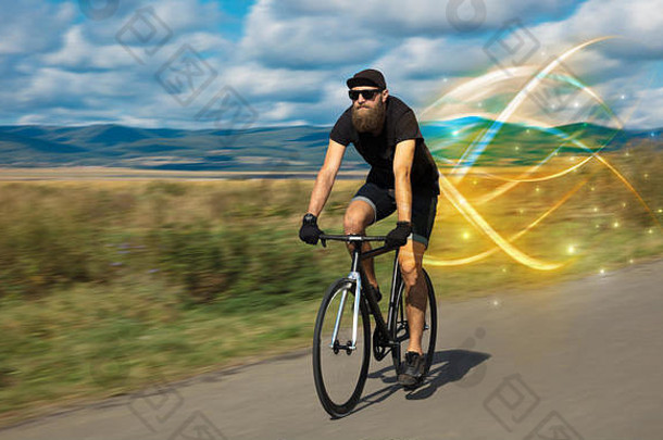 年轻的骑自行车的人骑自行车神奇的景观概念