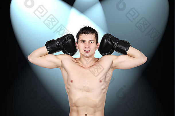戴拳击黑手套、肌肉发达的年轻拳击手