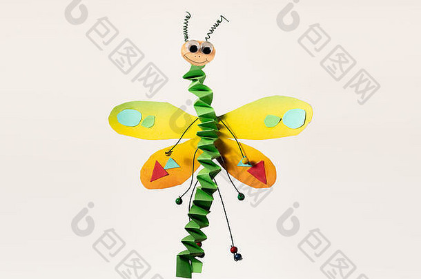 色彩斑斓的飞行蜻蜓使纸孩子白色背景