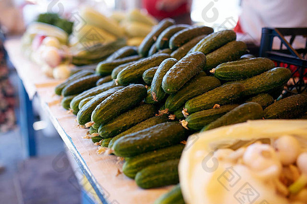 当地农民夏季户外市场上出售的新鲜有机蔬菜和水果。健康有机食品概念。黄瓜、大蒜和西葫芦。