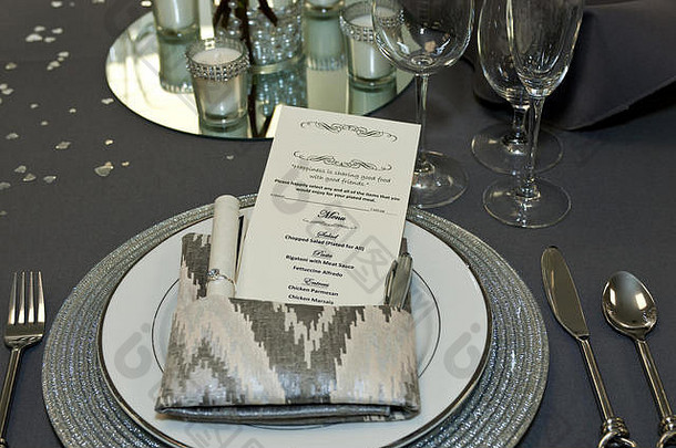 美丽时尚的婚宴桌，配有白色和银色的盘子