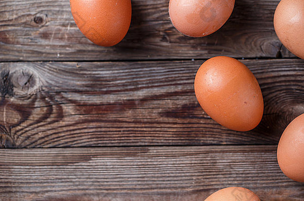 棕色的鸡蛋放在一张质朴的木桌上
