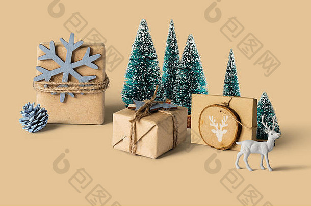圣诞礼物包裹，周围是小玩具松树和白色驯鹿，圣诞、冬季、新年或购物概念。前视图。