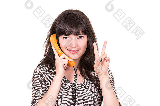 使用复古橙色电话的美丽年轻女子