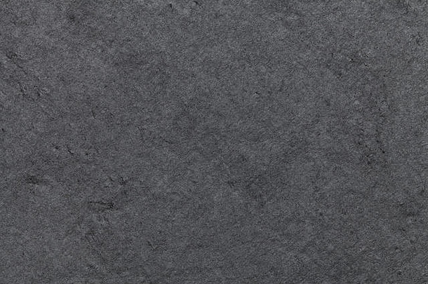 天然板岩的深灰色背景。纹理黑石特写。