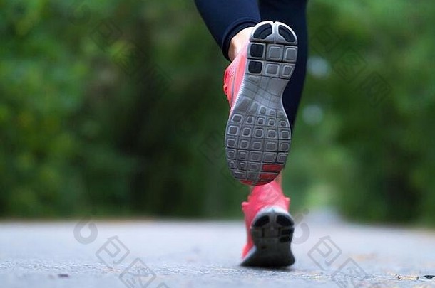 <strong>跑步</strong>者的脚。女人在森林里奔跑。特写照片。Helathy生活方式。