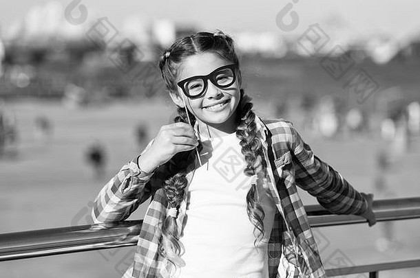 给每个孩子一个快乐的童年。可爱的小女孩，笑容可掬，戴着道具眼镜，表情滑稽。在夏<strong>日</strong>里，快乐的孩子带着灿烂的笑容。<strong>国际儿童</strong>节快乐。