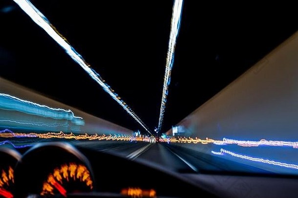 酒后驾车。从一个醉酒司机的眼睛里看到的景象。驾驶时隧道上灯光的长曝光照片。
