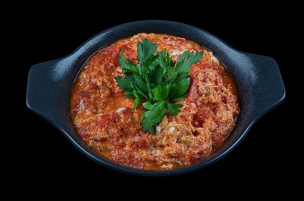 传统的土耳其Menemen使鸡蛋西红柿香料Menemen晚餐投锅黑色的背景