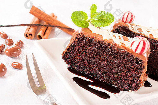 盘子里放着甜蜜的家庭巧克力蛋糕。选择重点放在前面的巧克力蛋糕上