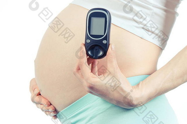 孕妇手持血糖仪测量血糖水平，妊娠期<strong>糖尿病的</strong>概念