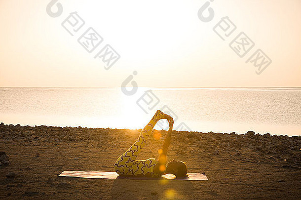 瑜伽练习。日出时做体式的女人