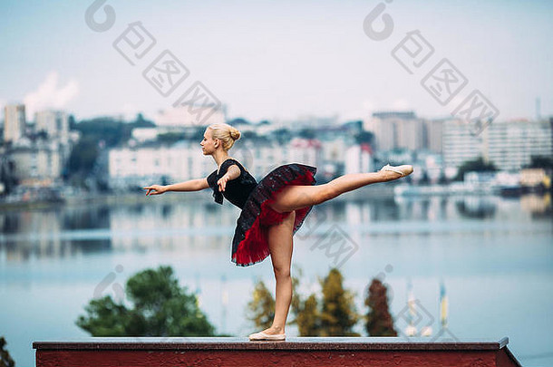 在湖面背景上摆姿势的芭蕾舞女演员