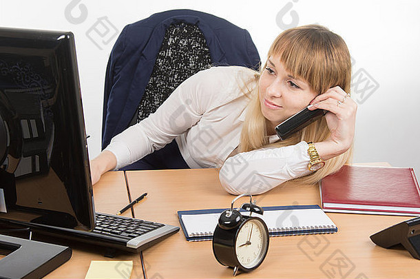 疲惫的办公室职员躺在办公桌上打电话，看着屏幕