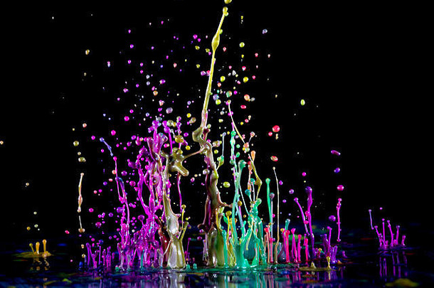 彩色喷溅颜料的抽象雕塑。黑色背景上跳舞的液体。水墨飞溅。色彩爆炸。