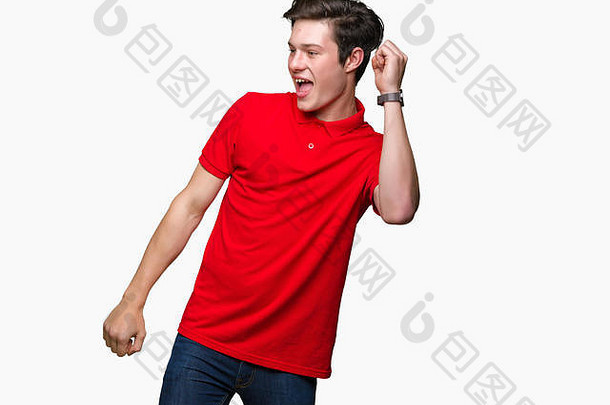 年轻英俊的男子穿着红色t恤衫，在孤立的<strong>背景</strong>下<strong>欢快</strong>地跳舞，微笑着，移动着，随意而自信地听着<strong>音</strong>乐