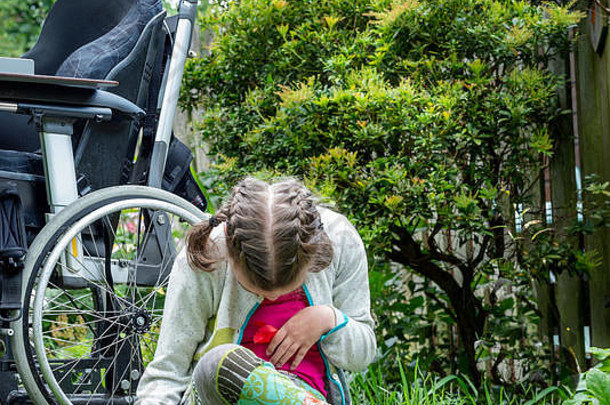 一个<strong>残疾儿童</strong>从坐在轮椅上探索她的自然环境中得到休息