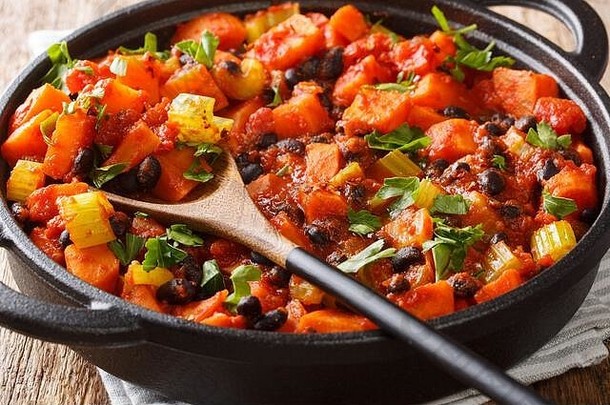 美味的辣的甜蜜的土豆黑色的豆子西红柿特写镜头锅表格水平
