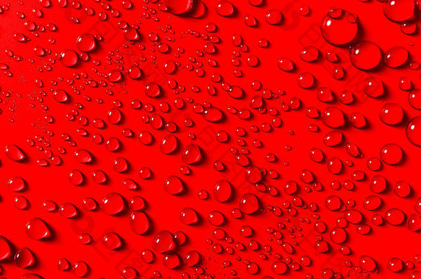 关闭色彩斑斓的节日红色的背景闪闪发光的水滴随机模式完整的框架纹理假期主题概念