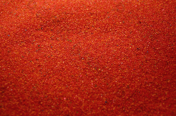 纹理彩色的细粒度的沙子关闭红色的谷物