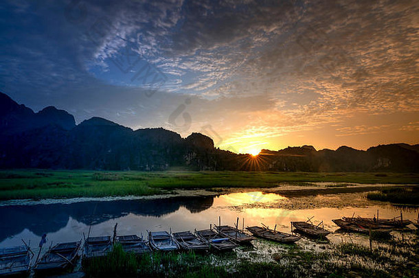 在阳光和水的反射下，万隆湿地保护区出现了神奇的黎明。越南Ninh Bình省的Van Long湿地保护区