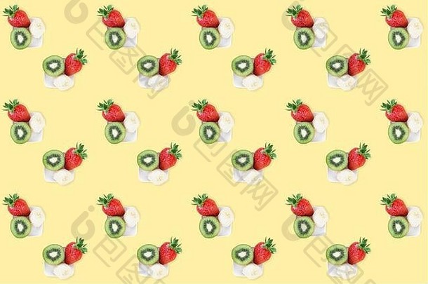 色彩斑斓的夏天水果混合模式新鲜的草莓猕猴桃香蕉块黄色的背景最小的平躺食物纹理