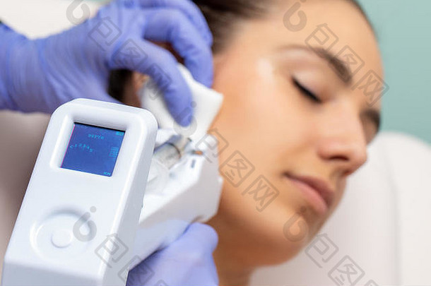 微针刺技术年轻的女人设备数字屏幕指示深度应用皮肤