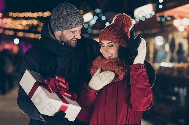照片爱的的家伙交付漂亮的夫人传统的x-mas礼品盒红色的弓浪漫时刻穿温暖的外套针织帽围巾在户外