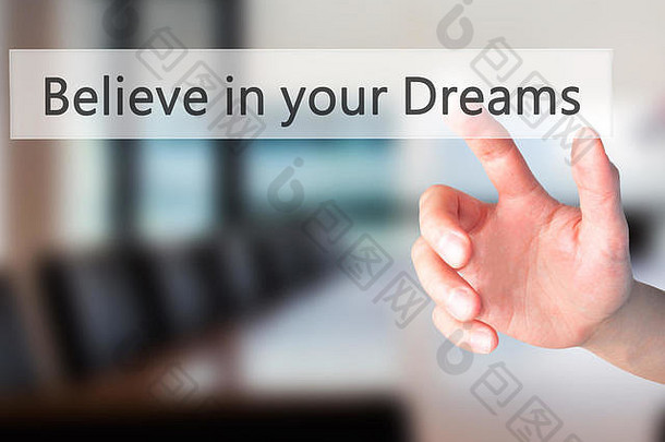 相信你的梦想-手按一个按钮模糊的背景概念。商业、技术、互联网概念。库存照片