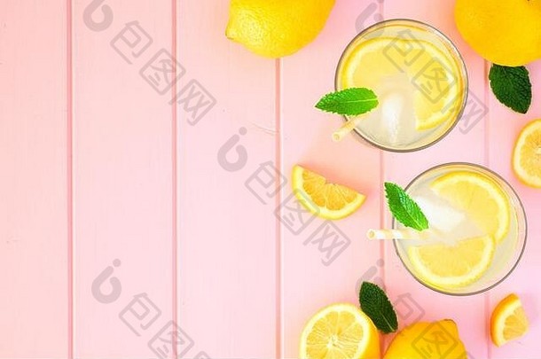 甜甜的<strong>夏日柠檬水</strong>。带有空间的顶视图侧边框，位于粉彩粉色木材背景上。