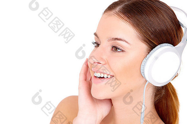 微笑年轻的女人听音乐耳机