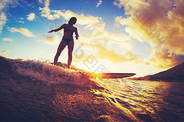 冲浪日落美丽的年轻的女人骑波日落户外活跃的生活方式