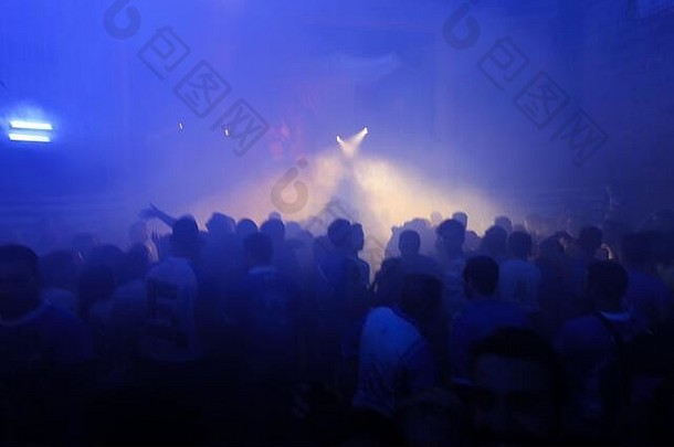人提高手蓝色的烟雾缭绕的背景光梁音乐会人群人跳舞