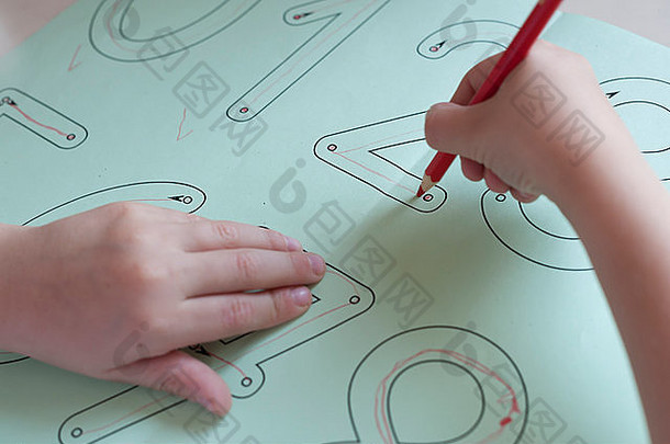 一个7岁的小学生正在做写作练习作为小学的家庭作业。