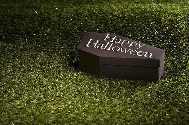 草坪上的万圣节棺材上写着“万圣节快乐”