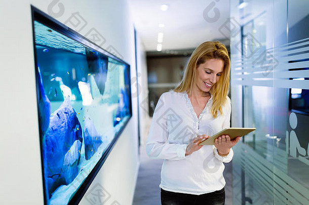 肖像成功的女商人持有数字平板电脑