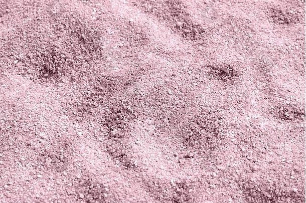 海滩沙子纹理特写镜头自然背景<strong>粉红</strong>色的颜色健美的