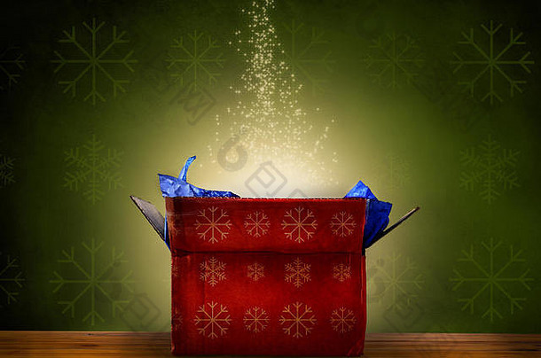 打开红色的圣诞节礼物盒子黄金雪花模式发射神奇的温暖的明亮的发光的光不断上升的闪闪发光的星星集