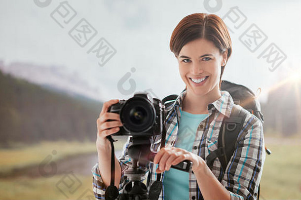 微笑女人徒步旅行在户外拍摄数字相机三脚架自然摄影概念