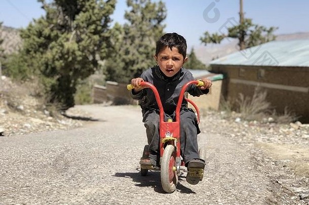一个小男孩带着奇怪的心情坐在他的<strong>自行车</strong>上