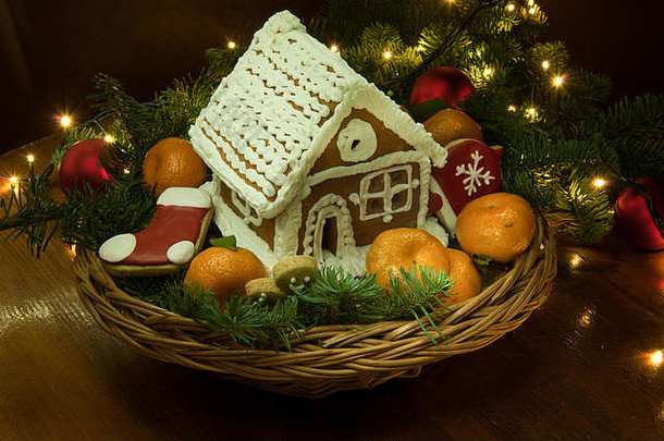 新年的圣诞甜饼有橘子和一个小房子，篮子里放着圣诞树枝和玩具