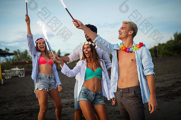 一群朋友在海滩上玩得很开心，带着火花