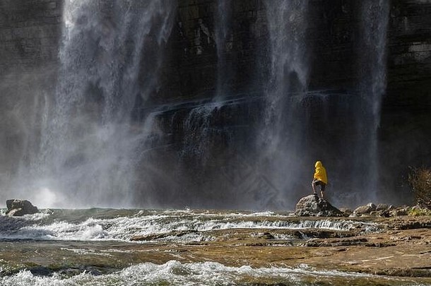 <strong>冒险者</strong>在土耳其看托尔图姆瀑布。穿着黄色夹克的游客在土耳其的托尔图姆瀑布放松。托尔图姆景观