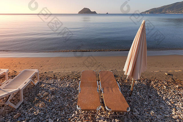 希腊Zakynthos岛海滩上带伞和躺椅的海岸晨景。暑期热门旅游目的地